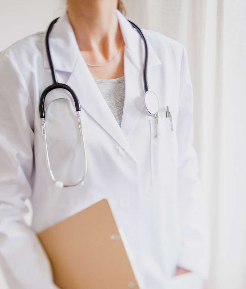 Physician wearing a stethoscope and holding a medical clipboard